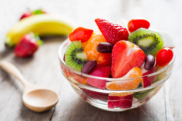 Diet-Fresh tasty mix fruit salad in the bowl on the wooden table
