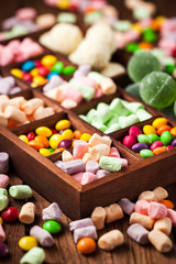 Mix of candies and sweets in wooden box