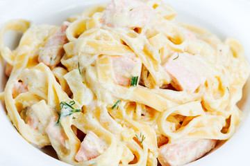 tasty pasta with salmon, dill on plate