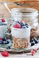 Superfoods concept : overnight chia pudding with homemade granola,fresh berries and honey. Healthy eating. Selective focus 