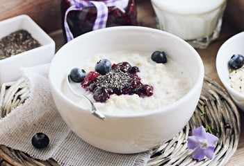 Oatmeal porridge with blueberry jam and chia seeds.Superfoods concept.