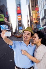 Fototapeta premium Composite image of man and woman taking a picture