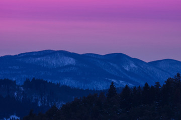 Sunset winter landscape with  violet and pink colors