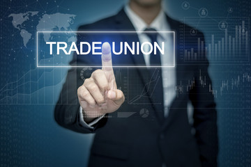 Businessman hand touching TRADE UNION  button on virtual screen