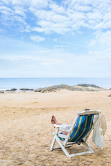 Young woman relaxing on a beautiful beach.