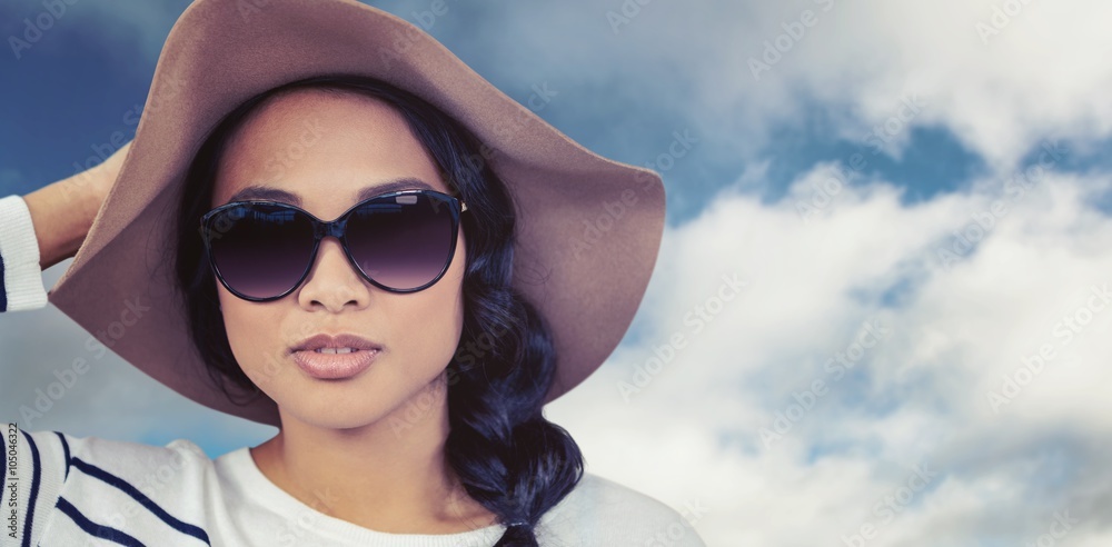 Wall mural Composite image of attractive asian woman with hat and sunglass