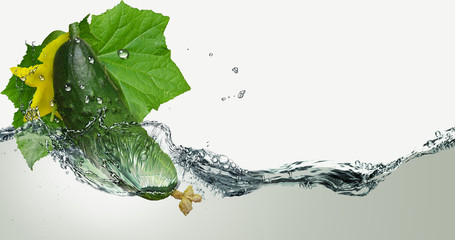 Fresh cucumber in spray of water.