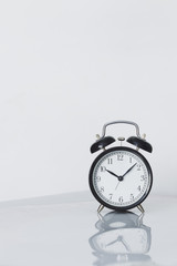 Alarm clock on white background, minimalism
