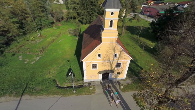 People goes in to the small catholic church 