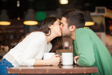 Young couple kissing in a restaurant