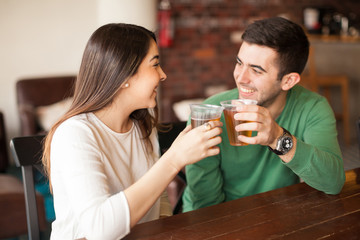 Couple drinking beer at a bar