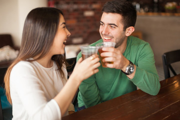 Couple giving a toast with beer