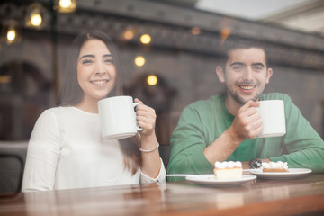 Happy young couple relaxing in a coffee shop