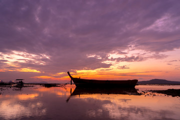 Long tail fishing boats at sunet