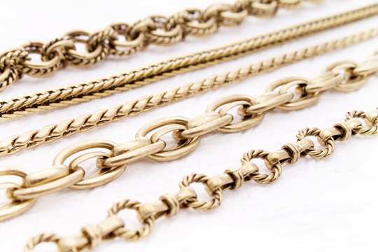 Beautiful Antique Gold Chains In Selective Focus On A White Background