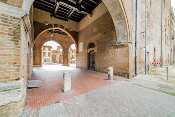Fototapeta na wymiar colonnade overlooking the medieval square in Rimini