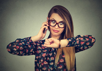 Stressed surprised business woman looking at wrist watch, running late for meeting.