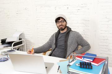 corporate portrait young hispanic attractive hipster businessman working with computer modern home office