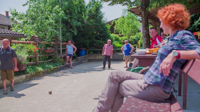 Viewers sitting on bench during bouling game