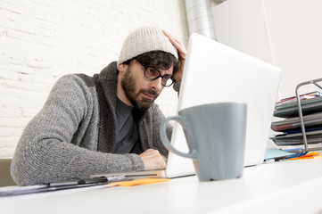 corporate portrait young hispanic attractive hipster businessman working with computer modern home office