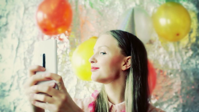 Happy birthday girl doing selfies on smartphone, steadycam shot
