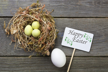 Easter eggs in nest on rustic wooden background, selective focus image, Card Happy Easter