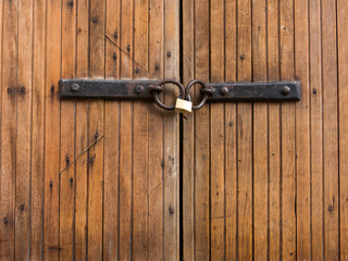 Padlock closing old wood door