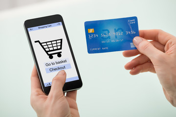 Businesswoman Hand Holding Credit Card And Mobile Phone