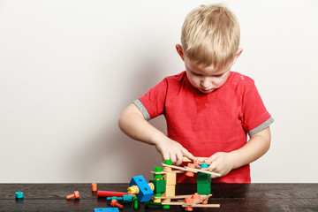 Fototapeta premium Little boy play with toy on table.