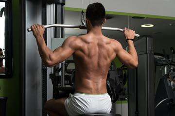Fototapeta na wymiar Arabic Man Doing Heavy Weight Exercise For Back
