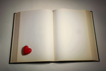 an open book and red heart