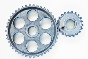 Two metal cogwheels on the light background