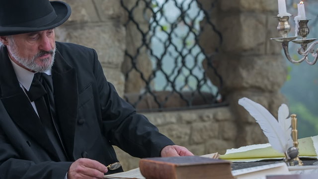 A composer seating down at the stone table 