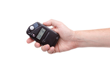 flash meter in hand on white background