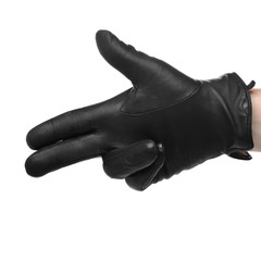 A human hand in black leather glove making a shooting gesturing,