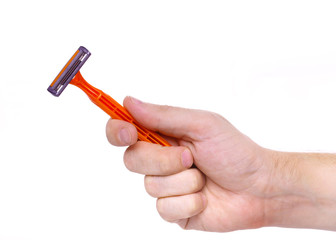 disposable razor orange color in a human hand isolated on white