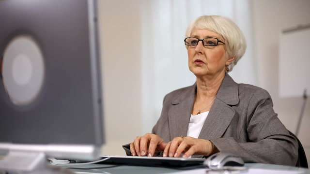 Senior businesswoman working on computer