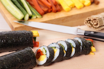 Cutting sushi on chopping board