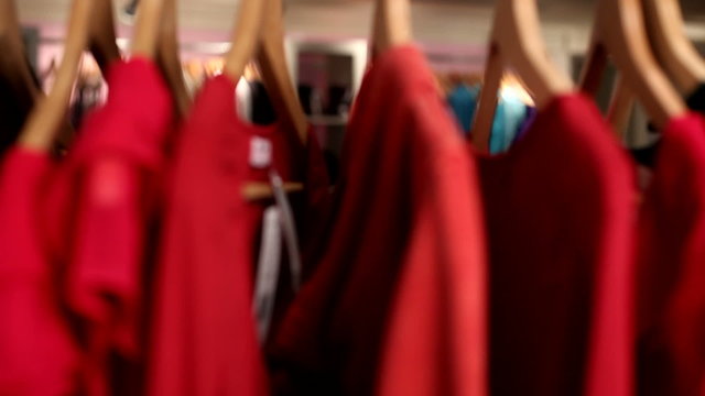 Shopper looking at clothing on rack