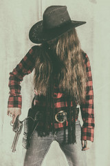 Cowgirl Gunslinger Holding Gun. Old west cowgirl gunslinger standing, holding peacemaker gun at her...