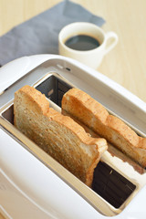 Toaster and two slices of bread ready to serve for the breakfast