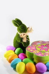Green grass Easter bunny rabbit with colorful Easter eggs