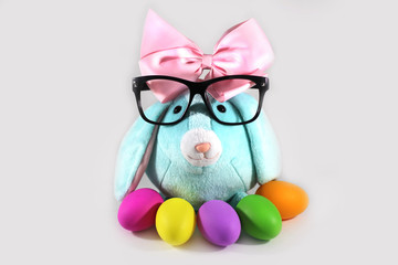 Office Easter. Blue Easter bunny rabbit with colorful Easter eggs and black eyeglasses