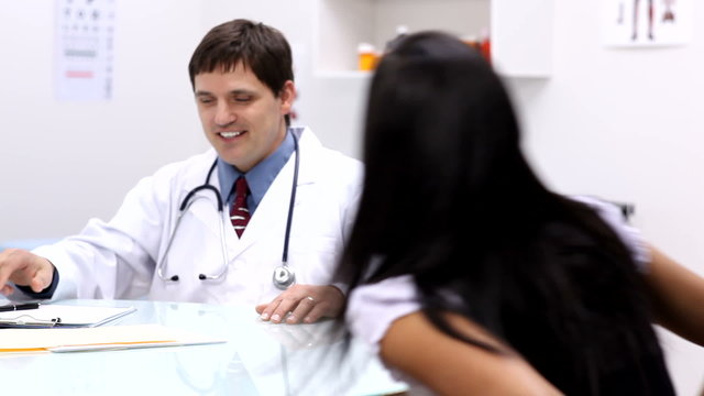 Doctor at desk consulting with patient