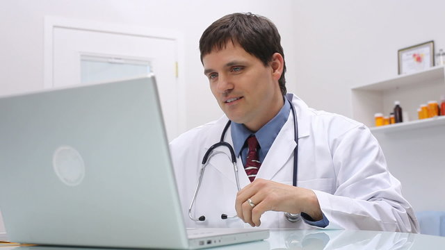 Doctor at desk using computer