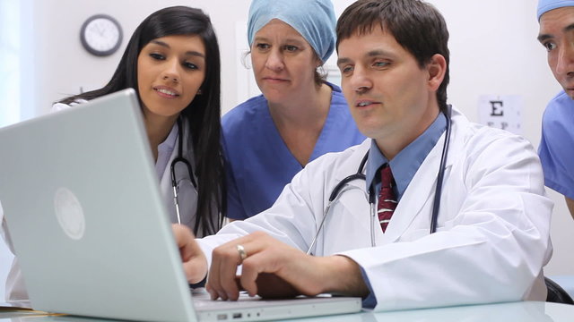 Medical personnel looking at laptop computer