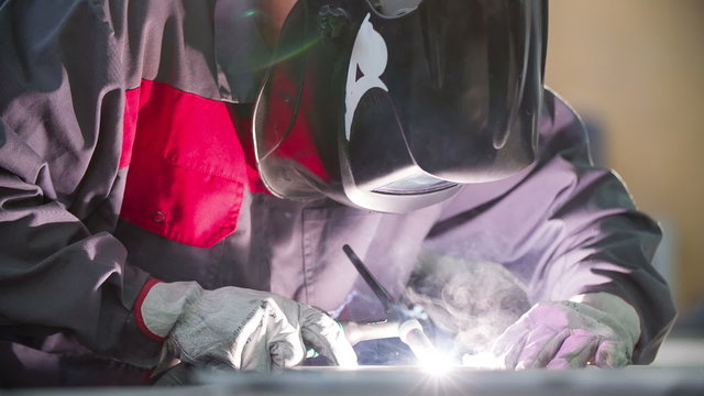 Worker is welding in slow motion