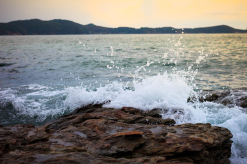 Water splashing. Crystal clear sea water beating against the roc