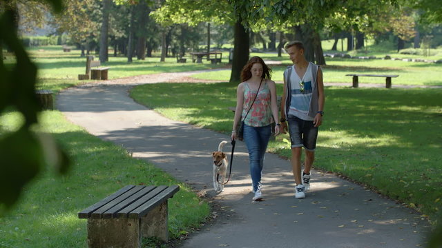 Couple In Love Walking On Path Through Park