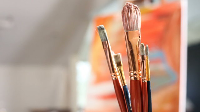 Artist picks up paintbrush